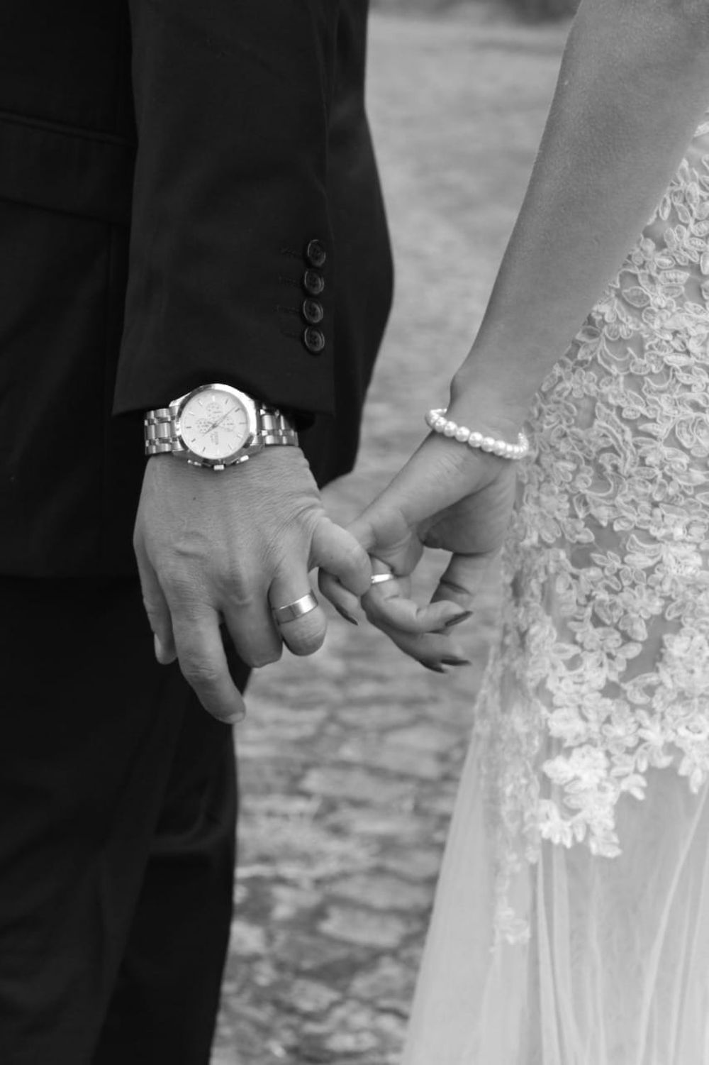 A romantic black and white photo capturing a couple holding hands in Pretoria, South Africa.