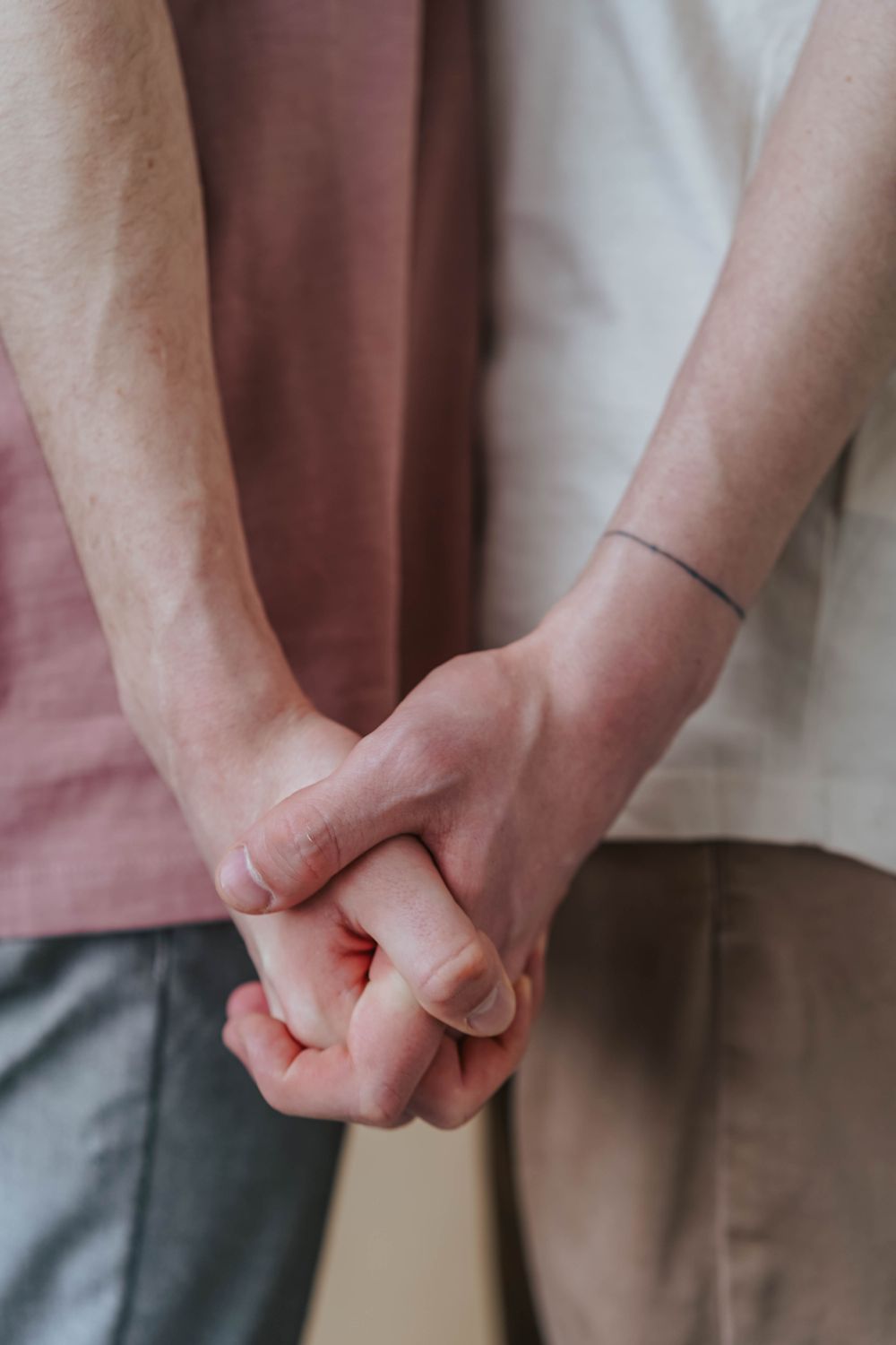 Tender moment captured as a couple holds hands, signifying love and connection.